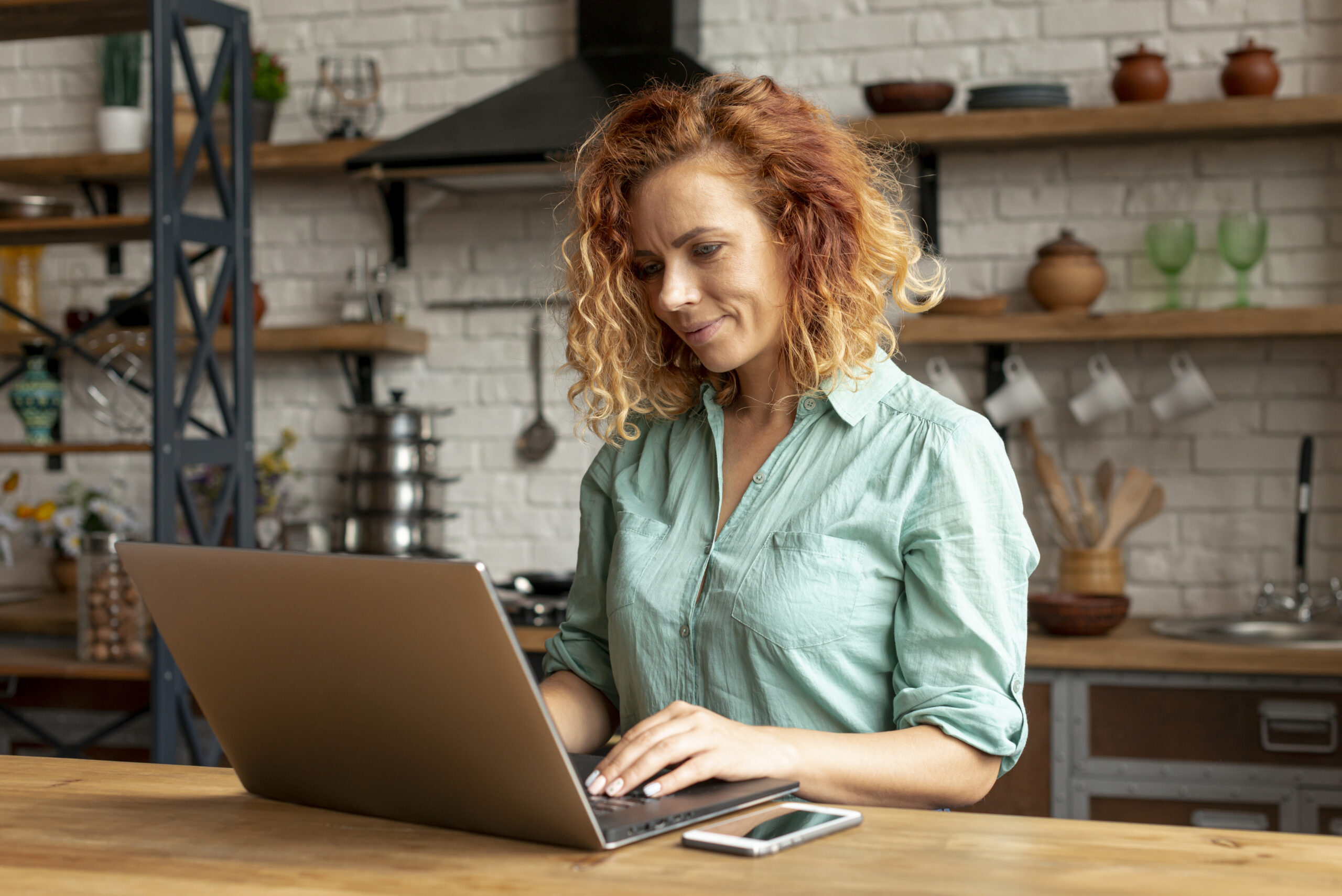 Professional working adult woman typing on laptop