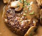 Salisbury steak with peppercorn gravy, caramelized onions, mashed potatoes & vegetables