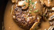 Salisbury steak with peppercorn gravy, caramelized onions, mashed potatoes & vegetables
